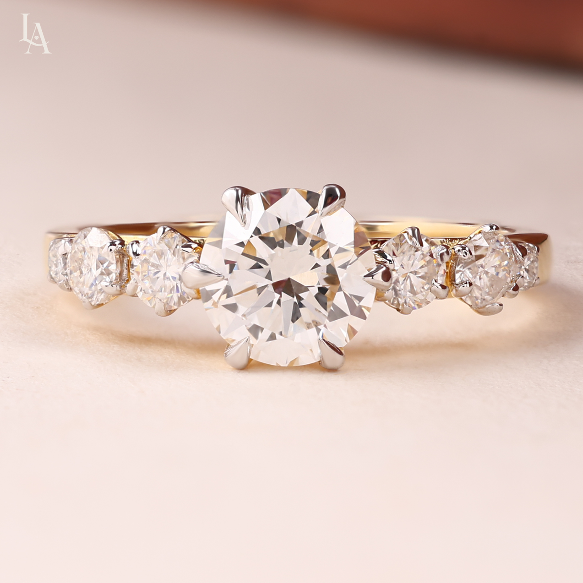 Round Cut Graduated Side Stone Engagement Ring